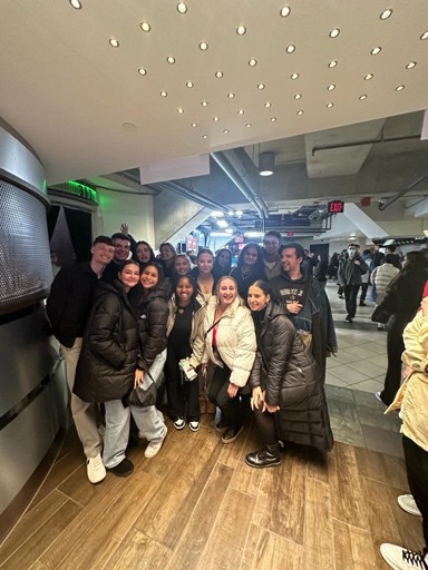 A group of friends smiling at the camera in a shopping centre