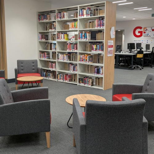 Library space with seating and a book case